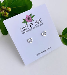 sterling silver double heart studs on a white card