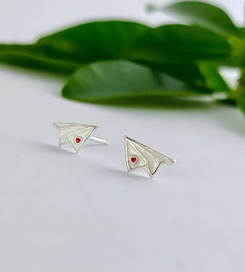 sterling siver and white paper plane earrings with a tiny red heart on the wing