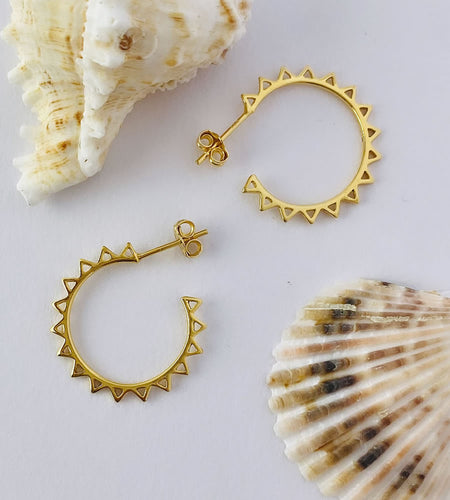 medium sized gold sun hoops with a stud fastening