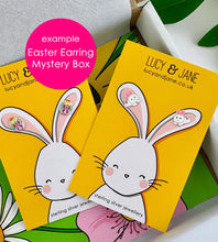 Load image into Gallery viewer, Mystery easter earrings box containing two Lucy and jane sterling silver easter earrings.  The photo shows two pairs of earrings on easter themed card - one pair of sterling silver colourful easter egg earrings and one pair of sterling silver leaping bunny studs