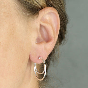 close up of sterling silver double hoop earrings on model
