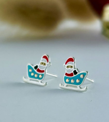 sterling silver christmas santa earring sitting in a sleigh
