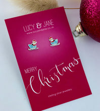 Load image into Gallery viewer, sterling silver santa sleigh earrings on a merry christmas backing card.