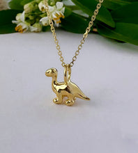 Load image into Gallery viewer, gold diplodocus dinosaur necklace.  Chunky small gold dinsosaur pendant on a gold chain