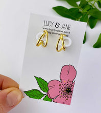 Load image into Gallery viewer, gold crossover hoops on a Lucy and Jane jewellery card