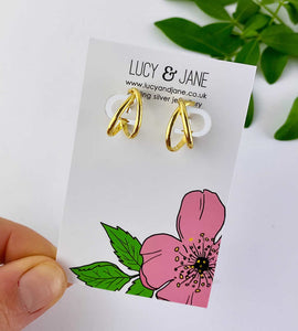 gold crossover hoops on a Lucy and Jane jewellery card