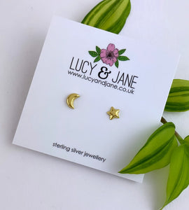 gold moon and star mismatched studs on a backing card