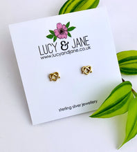 Load image into Gallery viewer, gold pretzel heart shaped ear studs, on a white backing card
