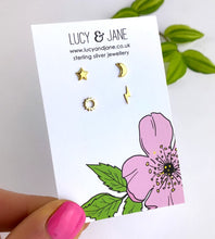 Load image into Gallery viewer, set of four mismatched studs in gold including a lightning bolt, star, moon and sun studs in gold