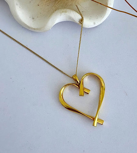 Gold twist heart necklace on a gold chain