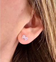 Load image into Gallery viewer, sterling silver sparkly pink bow studs in model&#39;s ear