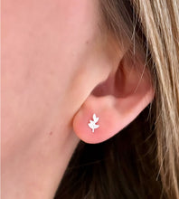 Load image into Gallery viewer, sterling silver tiny leaf studs in model&#39;s ear