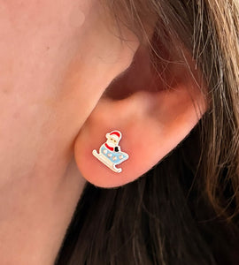 sterling silver santa in sleigh earrings close up in model's ear