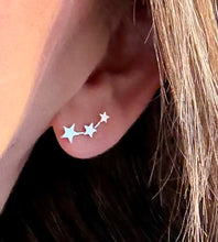 Load image into Gallery viewer, model wearing sterling silver graduated star climber earrings