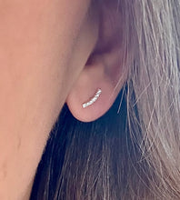 Load image into Gallery viewer, sterling silver sparkly curved bar earrings in model's ear