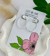 Load image into Gallery viewer, sterling silve oval diamond cut sleeper hoops on a lucy and jane card