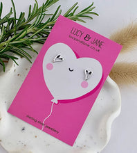 Load image into Gallery viewer, sterling silver open heart stud earrings displayed on a pink valentine's card