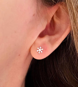 sterling silver snowflake studs in model's ear