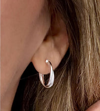 Load image into Gallery viewer, sterling silver double hoop crossover earrings in model's ear