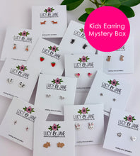 Load image into Gallery viewer, Lucy &amp; Jane kids earring mystery box with various pairs of earrings on display.