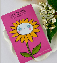 Load image into Gallery viewer, sterling silver sparkly small blue flower stud earrings for children on a cheerful sunflower backing card