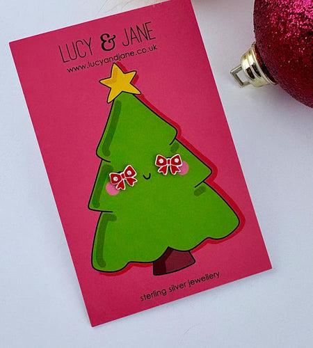 sterling silver red bow christmas earrings on a festive christmas tree backing card