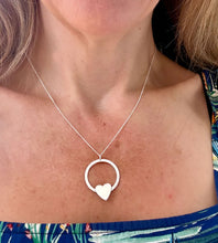 Load image into Gallery viewer, sterling silver circle necklace with a heart on a model's neck