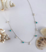 Load image into Gallery viewer, sterling silver necklace with turquoise beads and pearls on a white background with seashells.