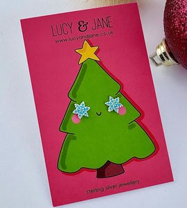 sterling silver blue frosty snowflake earrings on a card with a christmas tree