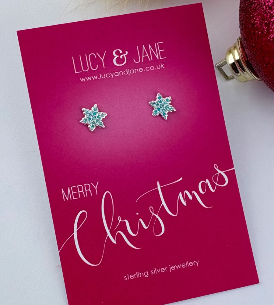 sterling silver blue frosty snowflake earrings on a merry christmas card