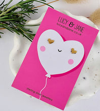 Load image into Gallery viewer, Gold heart stud earrings on a Valentine's card