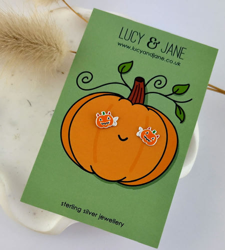 sterling silver pumpkin devil stud earrings on a Halloween backing card.  The pumpkin earrings are orange with tiny red devil horns and a tail