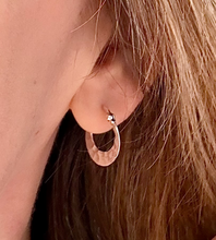 Load image into Gallery viewer, sterling silver hammered hoops in model's ear