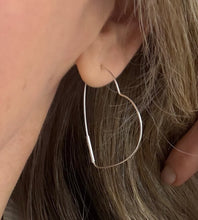 Load image into Gallery viewer, model wearing large heart hoop earrings in sterling silver