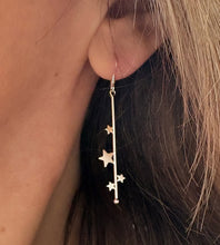 Load image into Gallery viewer, sterling silver long star earrings on model