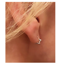 Load image into Gallery viewer, sterling silver small star hoops in model's ear