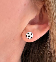 Load image into Gallery viewer, sterling silver football earrings in a model's ear