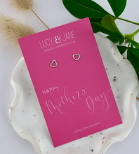 Load image into Gallery viewer, sterling silver open heart stud earrings on a mothers day backing card