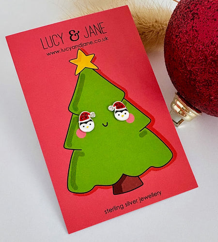 sterling silver penguin earrings wearing a sparkly santa hat on a Christmas card