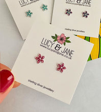 Load image into Gallery viewer, sterling silver pink sparkly flower studs with some purple flower studs and blue flower studs in the background.