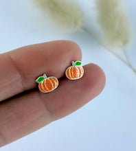 Load image into Gallery viewer, close up of the sterling silver pumpkin stud earrings. Orange pumpkin studs with a little green leaf.