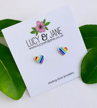 Load image into Gallery viewer, Rainbow heart earrings on a Lucy &amp; Jane card with green leaves in the background