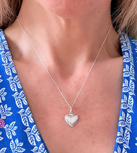 sterling silver shell heart necklace on a model's neck