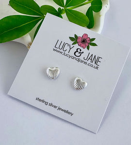 Silver heart shell-shaped earrings on a Lucy & Jane branded card.