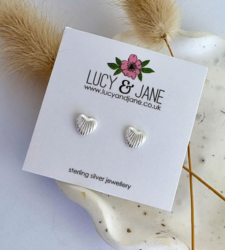 sterling silver shell heart shaped stud earrings on a Lucy and Jane card