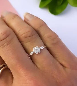 sterling silver sparkle flower ring on model's finger