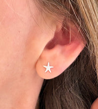 Load image into Gallery viewer, sterling silver starfish earrings in model's ear