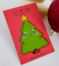 Load image into Gallery viewer, sterling silver t rex earrings wearing a santa hat.  On a Christmas card