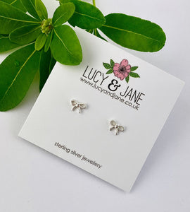 sterling silver small bow earrings on a white card