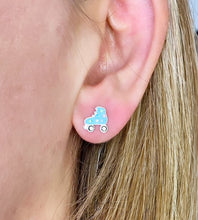 Load image into Gallery viewer, sterling silver sparkly blue roller skate studs in model&#39;s ear